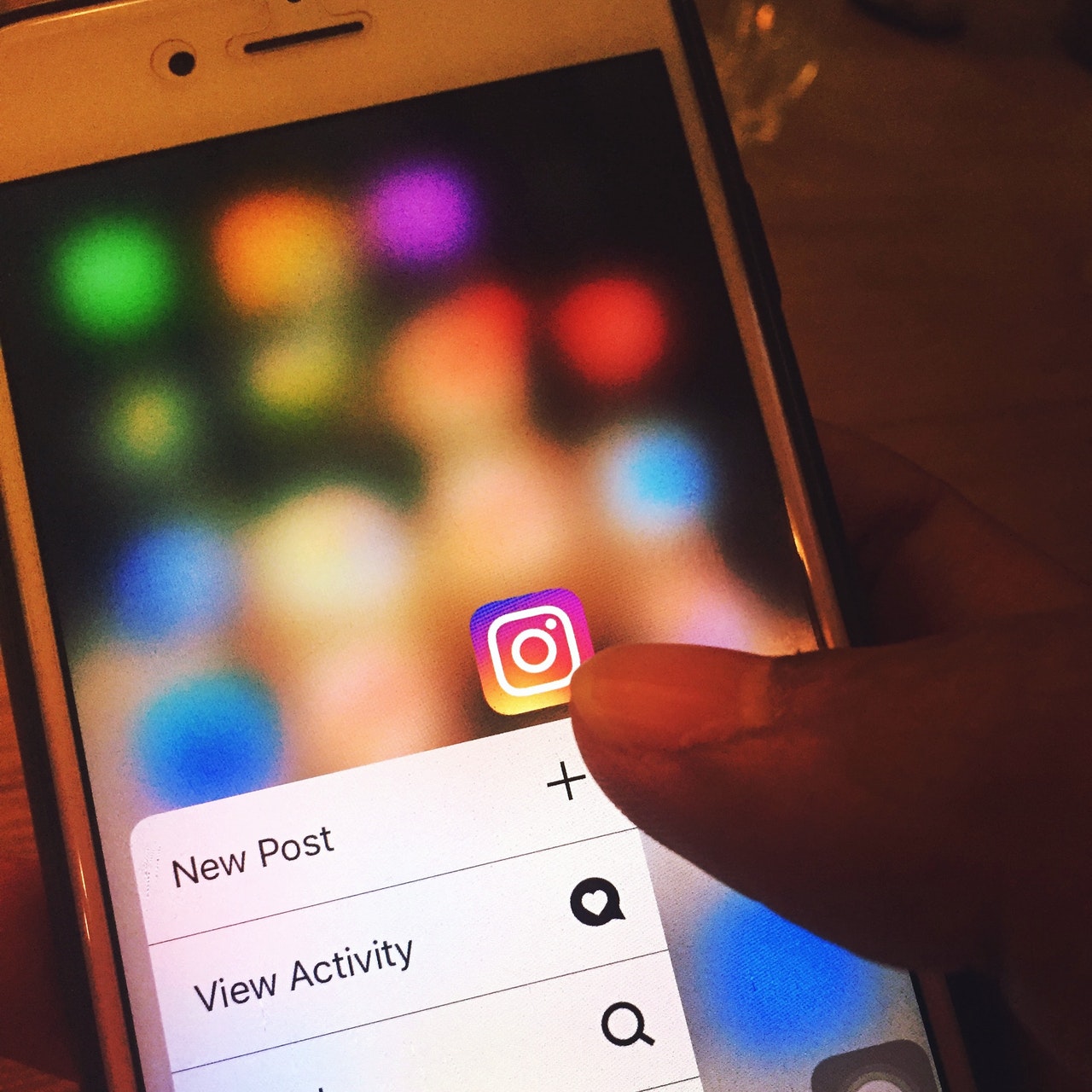 Image of person using phone to make a new post. Purpose of this is to show how quick, easy and cost effective it is to digital market.