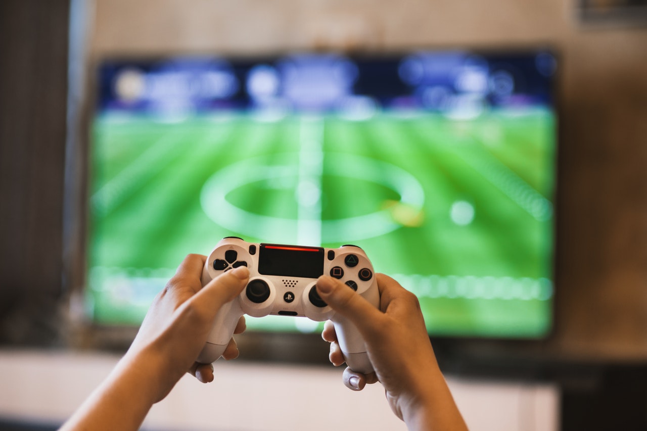 photograph of person holding game pads
