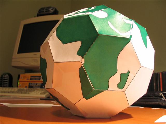 Photo of THE earth theme soccer ball and a computer behind it