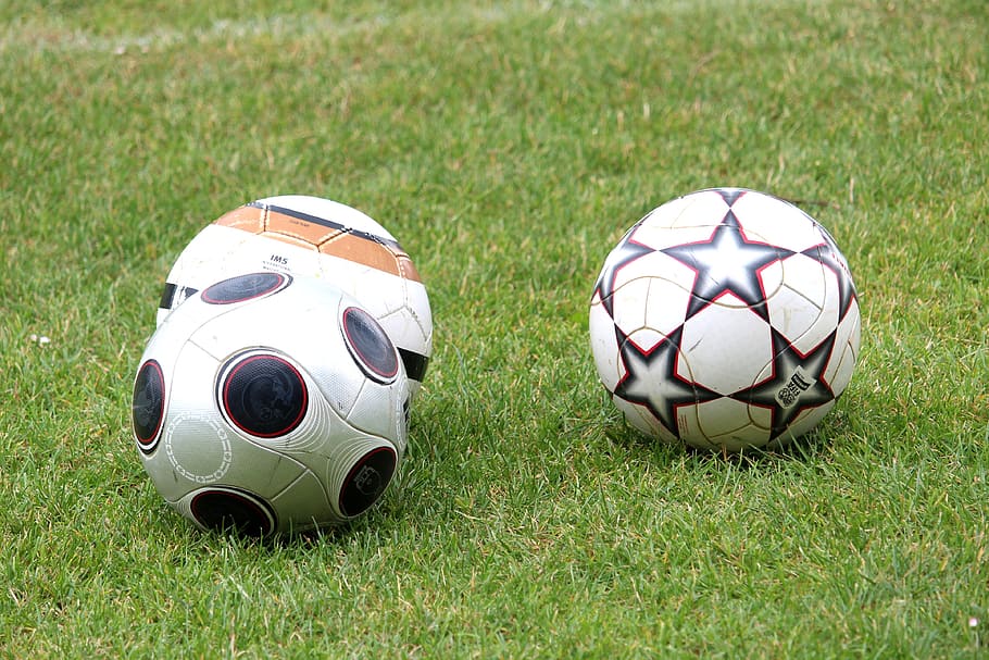 photo of three different soccer balls