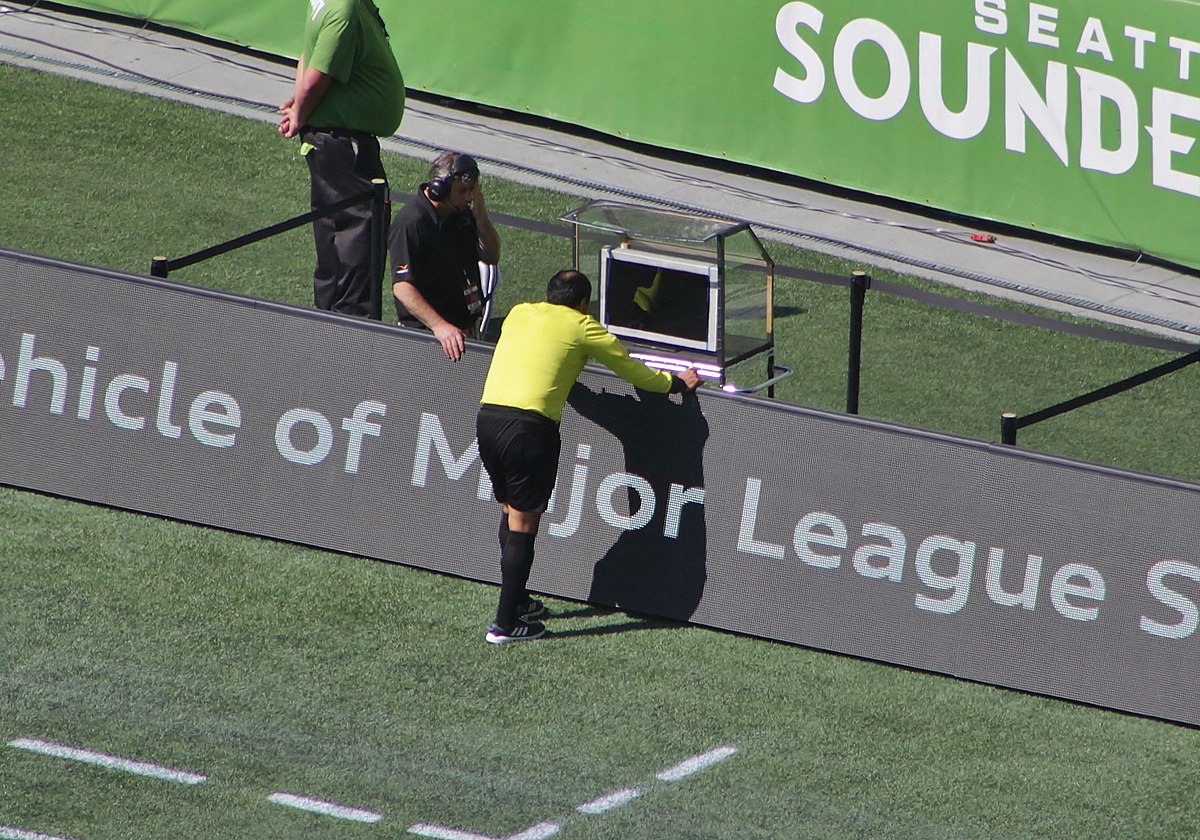 photo of a referee using VAR(video assistan referee) review